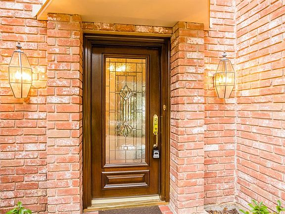 A solid wood door with decorative leaded glass invites you in to this beautiful home.