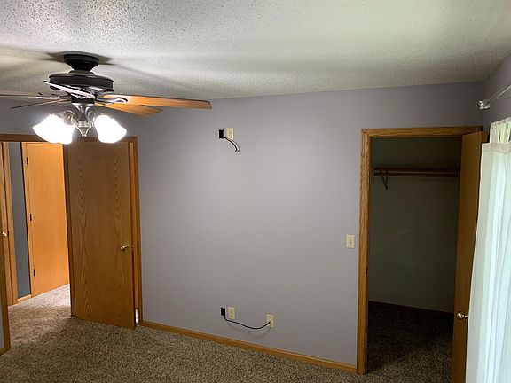 Master bedroom showing walk in closet and door to adjoining bathroom.