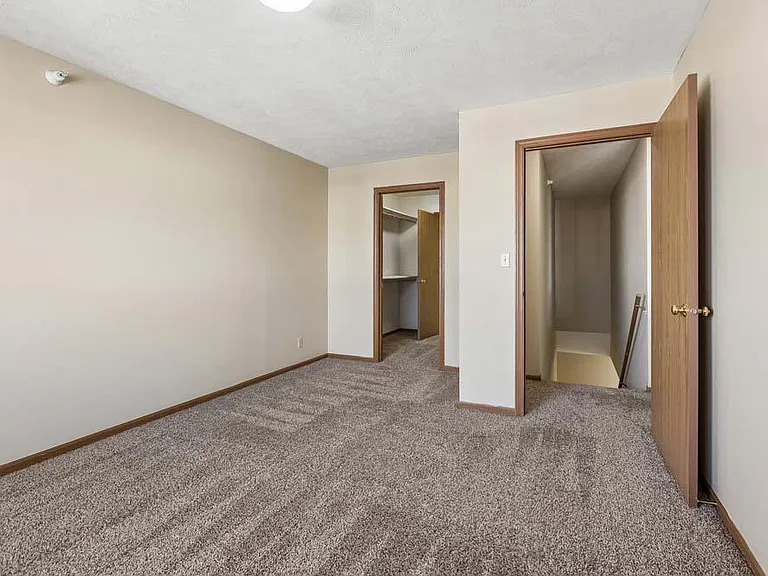 A spacious bedroom with a bright, open layout offers a comfortable retreat and easy access to the rest of the home.