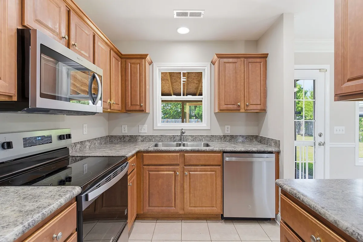Kitchen with brand new dishwasher and refrigerator - 7211 Chipley Dr