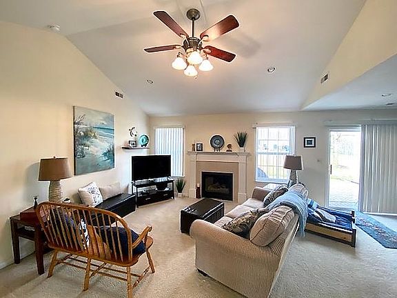 Living Room includes Gas Fireplace, Vaulted Ceiling and Bright Windows.