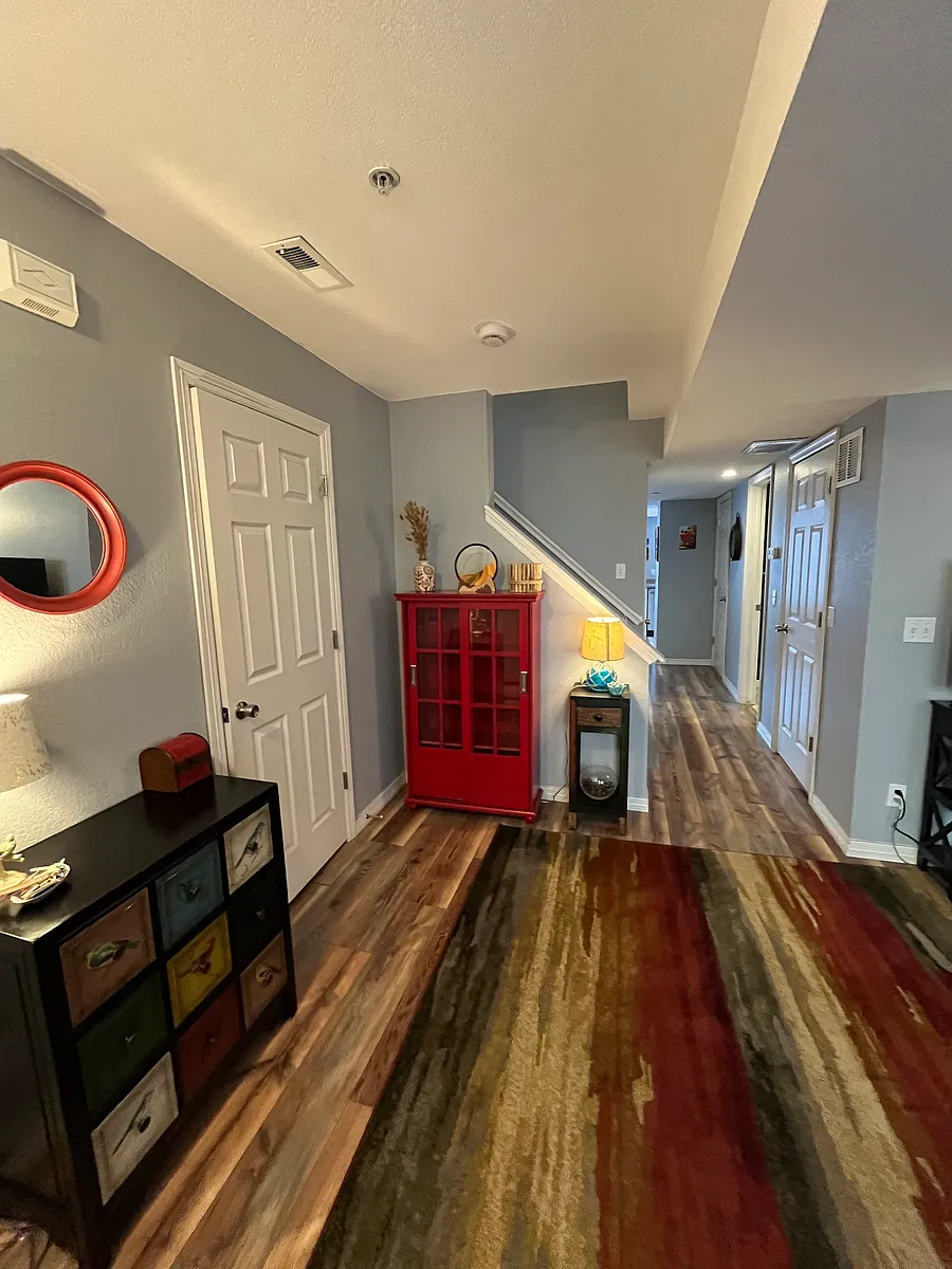 Living room with a hallway closet on the left. - 979 Laramie Blvd #F