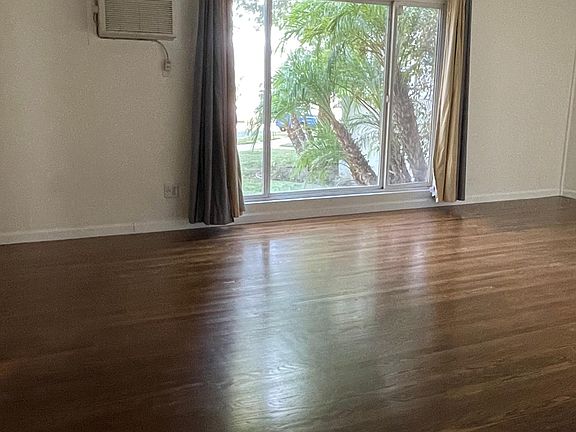 Large living room with picture window and a/c and heat unit