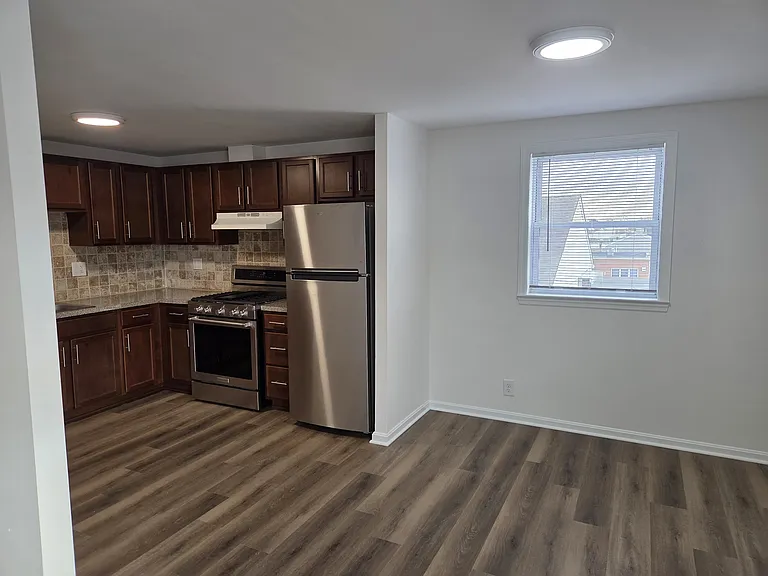 Kitchen is adjacent to an open space dining and living room.
