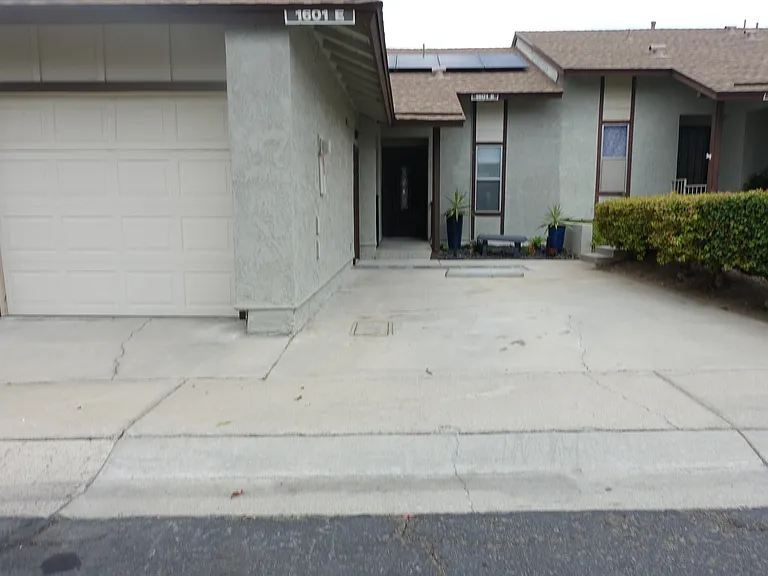 Garage: Single car. Remote control rolling door. Detached with side door entry/exit and keyless lock. Wall mounted cabinets and overhead storage area. Secondary refrigerator freezer. 
Driveway: Parking for single car