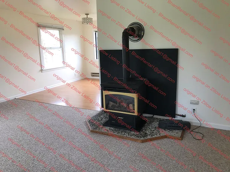 Living room carpeted. Nat. gas fireplace heats well insulated home.