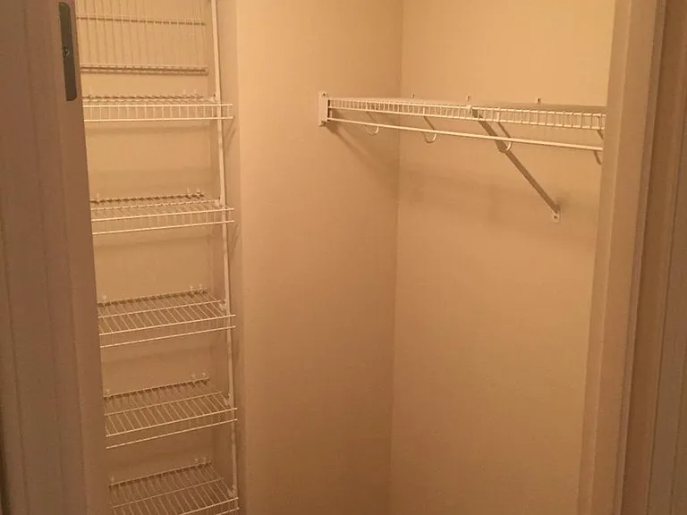 Walk in closet with shelving on both sides