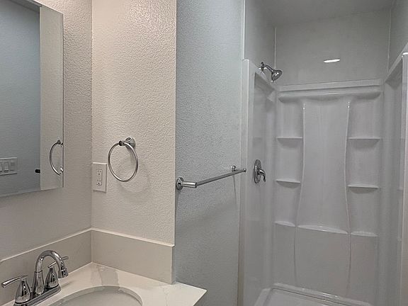 Bathroom with shower;
The door has been installed after the picture was taken