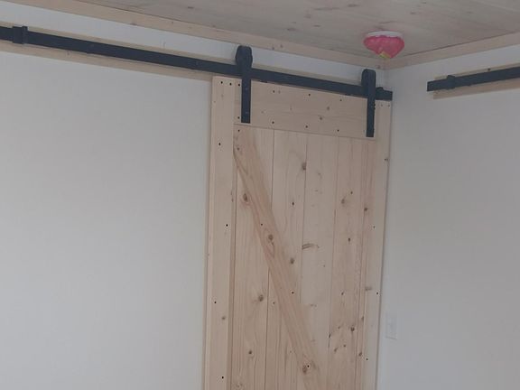 Bedroom, nice sized space with sliding barn doors and easy a