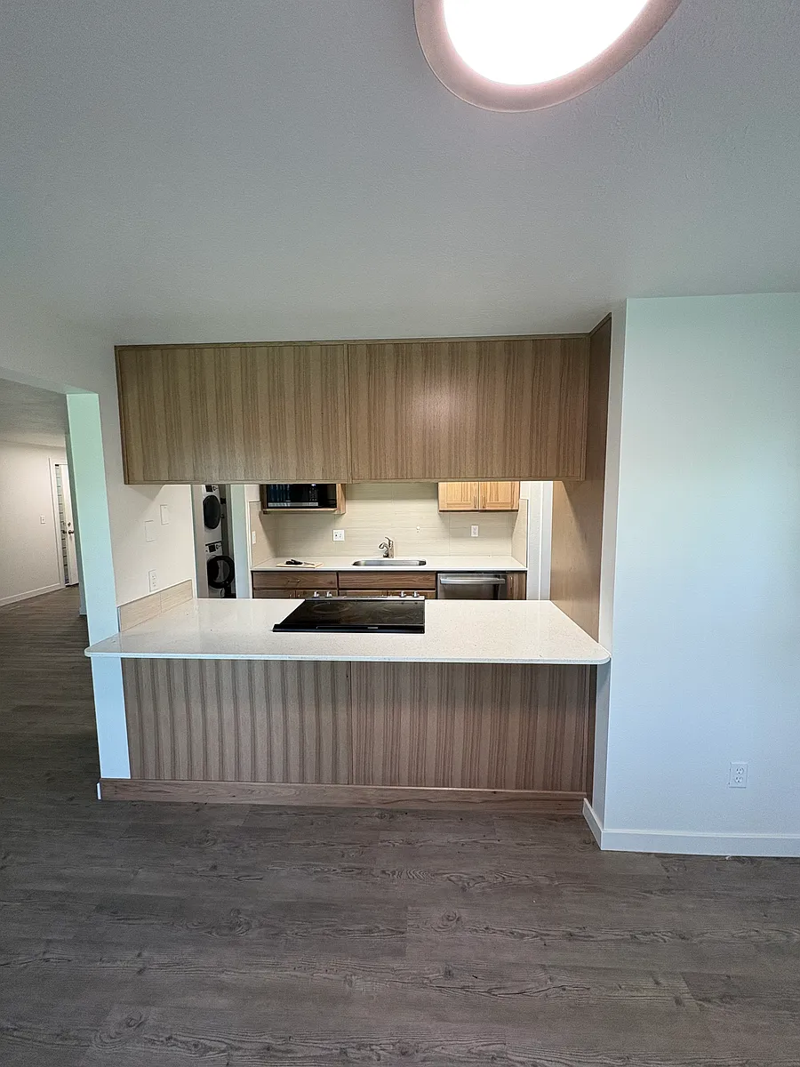 Kitchen penisula opening to living and dining area - 9011 E South Riverway Ave