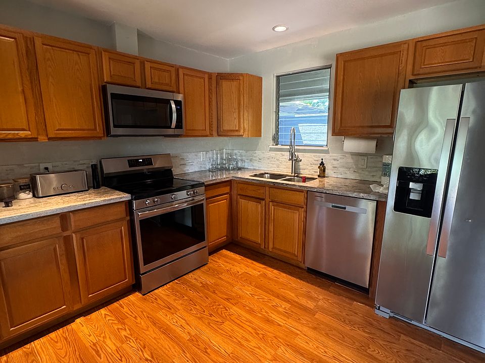 Kitchen with NEW appliances, dishwasher, refrigerator, stove, and microwave.