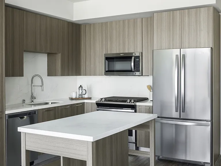 Gorgeous kitchen with stainless steel appliances, island and upscale grey finishes