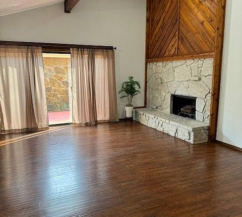 Living room with fireplace and patio door with deck