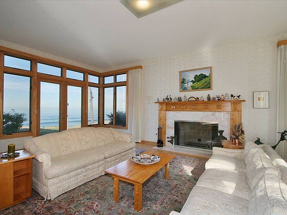Living room with marble fireplace overlooing the ocean