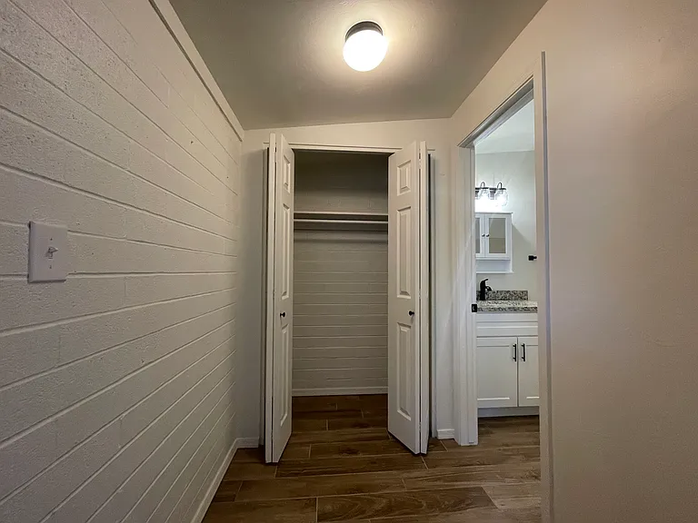 Hallway w/ closet and Primary Bathroom