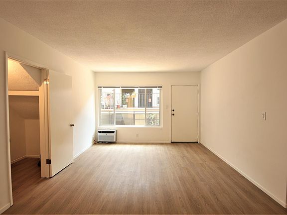 Living room has new floors & new AC. Lots of sunlight & large closet.