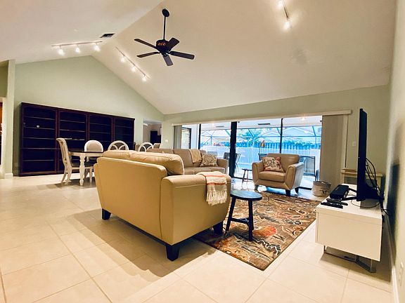 Huge open floor plan overlooks pool and patio