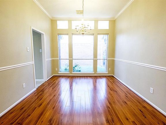 Share a meal in the formal dining room with decorative molding, beautiful chandelier and lots of natural lighting!