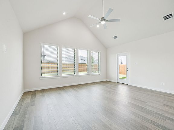 Living Room in the Claret home plan by Trophy Signature Homes - REPRESENTATIVE PHOTO