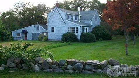 view from side with stone walls and barn