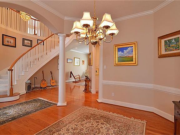 The coziness of the dining room is accented by the curved staircase and high ceilings in the entryway.