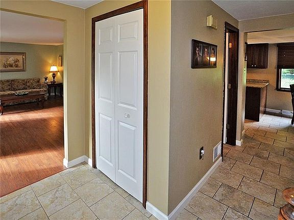 Easy access to the Living Room, Kitchen, and first floor Family Room. Neutral ceramic tile flows to the Kitchen. Six panel doors