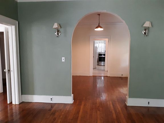 living room into dining room. front bedroom is to the left. kitchen is in the rear.
