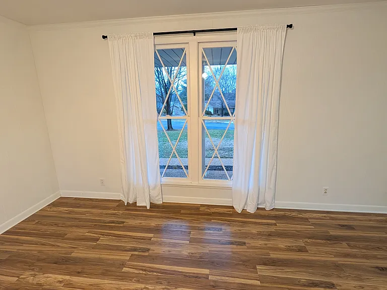 view of front window with privacy curtains