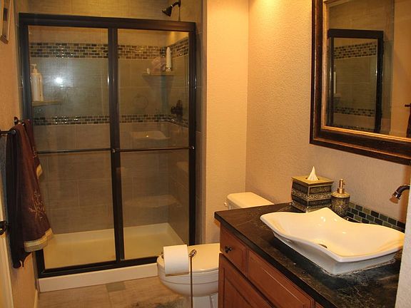 Main floor bathroom with sliding shower door and ornate mirr