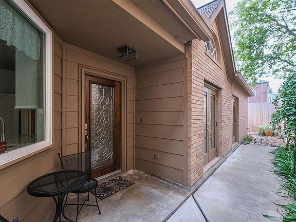 As you round the corner, the beautiful glass door welcomes you to come inside. Notice that there's enough room for a small table