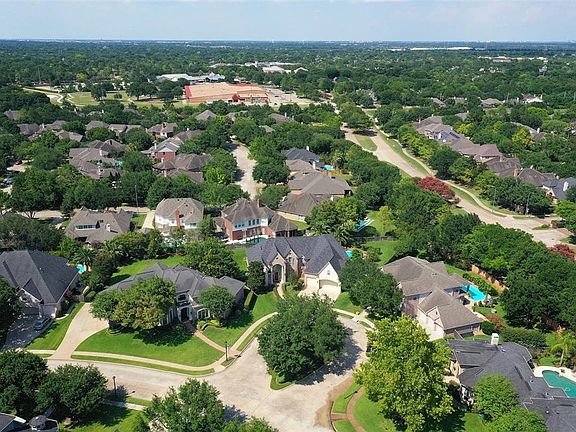 Perfectly situated in the heart of Cinco Ranch, this executive home is one of 90 custom homes in quiet Bayou Oaks located conveniently near all commuter routes. You will love living close to shopping, restaurants, grocery stores and the YMCA!