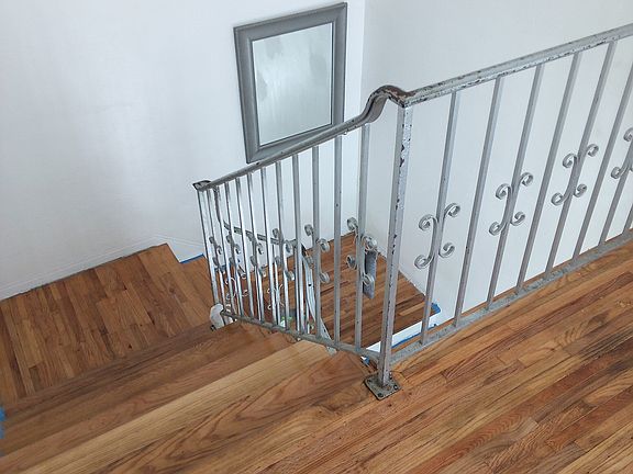 Front stairway undergoing renovation to original wood and refinished.