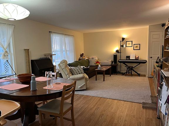 Large living room with dining area and generous windows in apartment