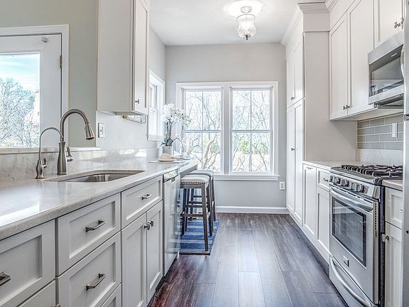 Spacious kitchen with white granite countertops