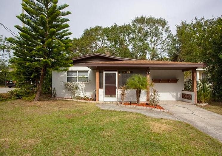 Front of house. Enclosed front porch.