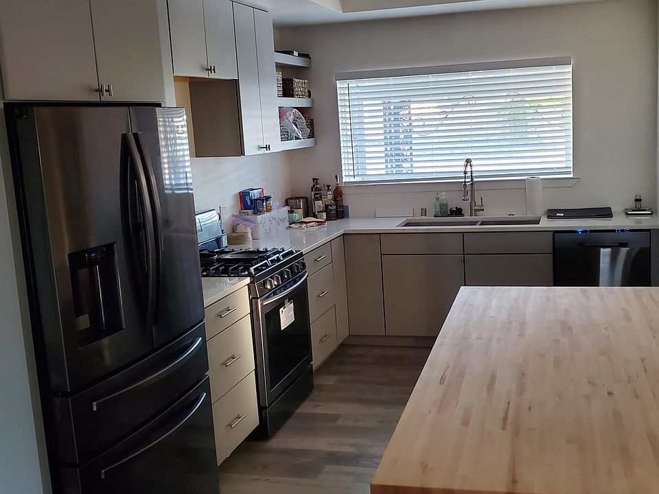 Newly Remolded Kitchen: Black Stainless Steel appliances. Backsplash and Over-The-Range Microwave are being installed.