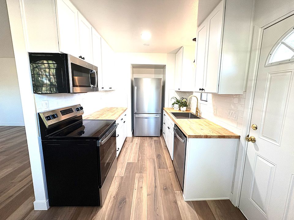 Stunning kitchen with all new stainless steel appliances, ample storage and counter space.