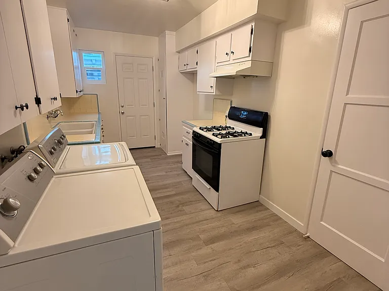Freshly Painted Cabinets with Rubbed Bronze finish, Double Deep Sink, New Lighting Fixture, Built in Pantry, and yes- a built in Washer and Dryer!