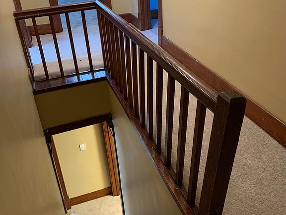 Stairway to upstairs bedrooms with new carpet and handrail