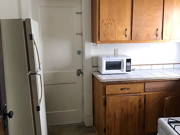 Kitchen with door access to shared laundry in the basement.
