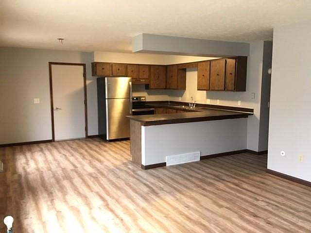 Open living room/kitchen area with stainless appliances and plenty of storage and counterspace and breakfast bar. (New ceiling fan has been installed in dining area since this last picture).