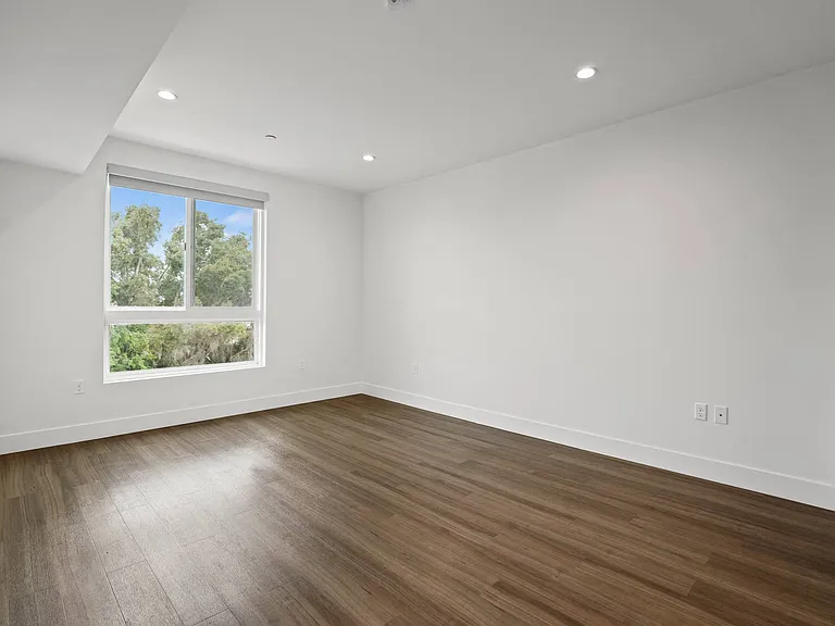 Spacious Bedroom with Recessed Lighting, Vinyl Flooring, And Large Windows
