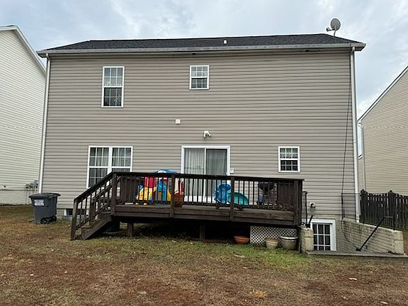 Back of house with deck and walkout basement