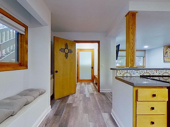 Bench seat in kitchen area with storage below. Kitchen window keeps it light and bright.