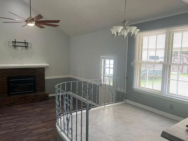 Sunken family room with toasty fireplace and door to covered patio. TV mount for large flat screen.