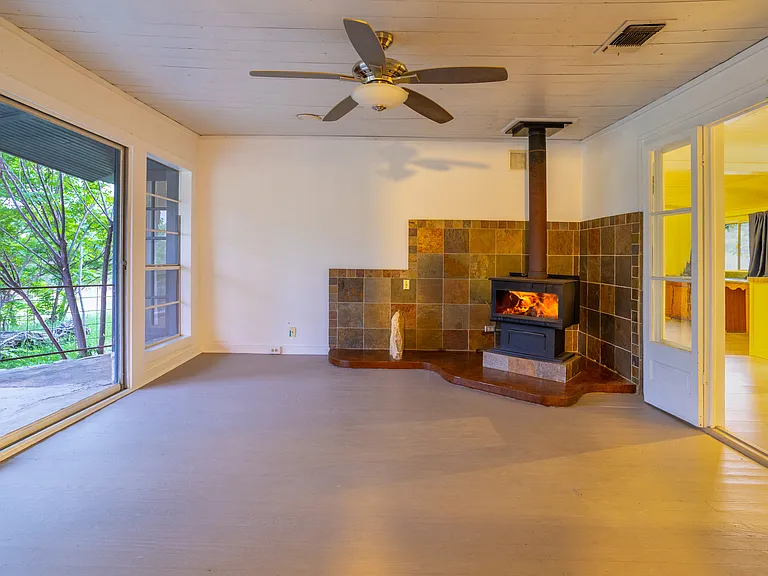 Living Room with Wood Burning Stove and Large Windows