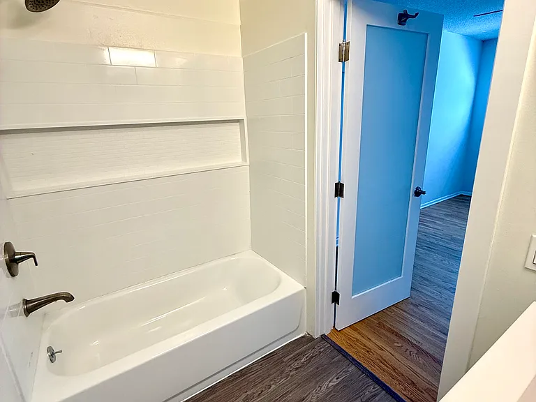 View of the bathroom and the door leading into the bedroom.