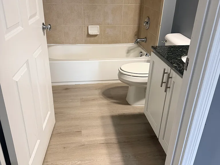 Bathroom#2 with new LVP floor and upgraded light fixtures.