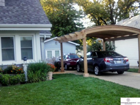 Summer view of the newer pergola cedar car port! Car protected from morning frost and even drifting 