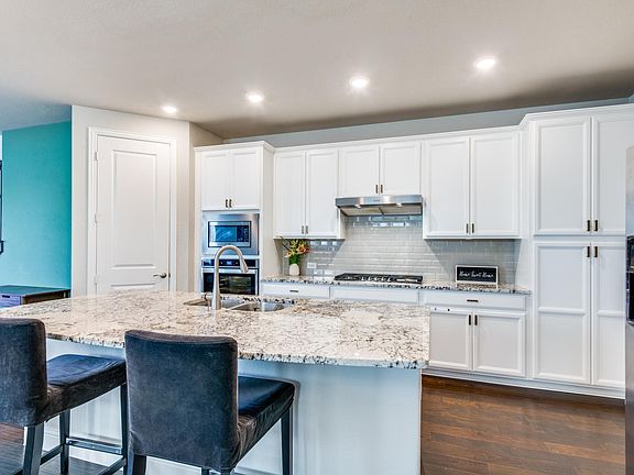 Beautiful white cabinets throughout kitchen with gold hardware.